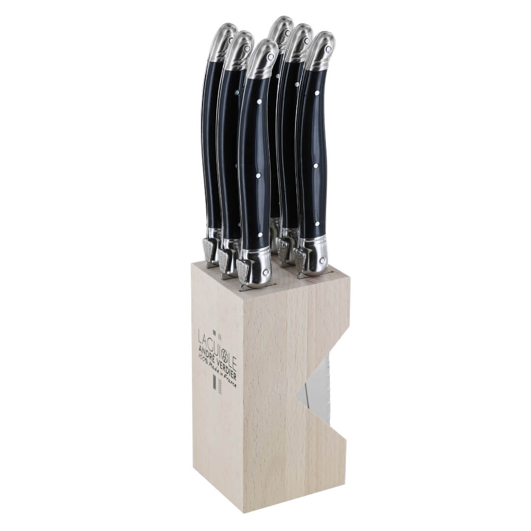 A 6-piece steak knife set with black handles and silver bolsters, presented in a light natural wood block on a white background. The block features the 'La Table des Champs' brand logo.