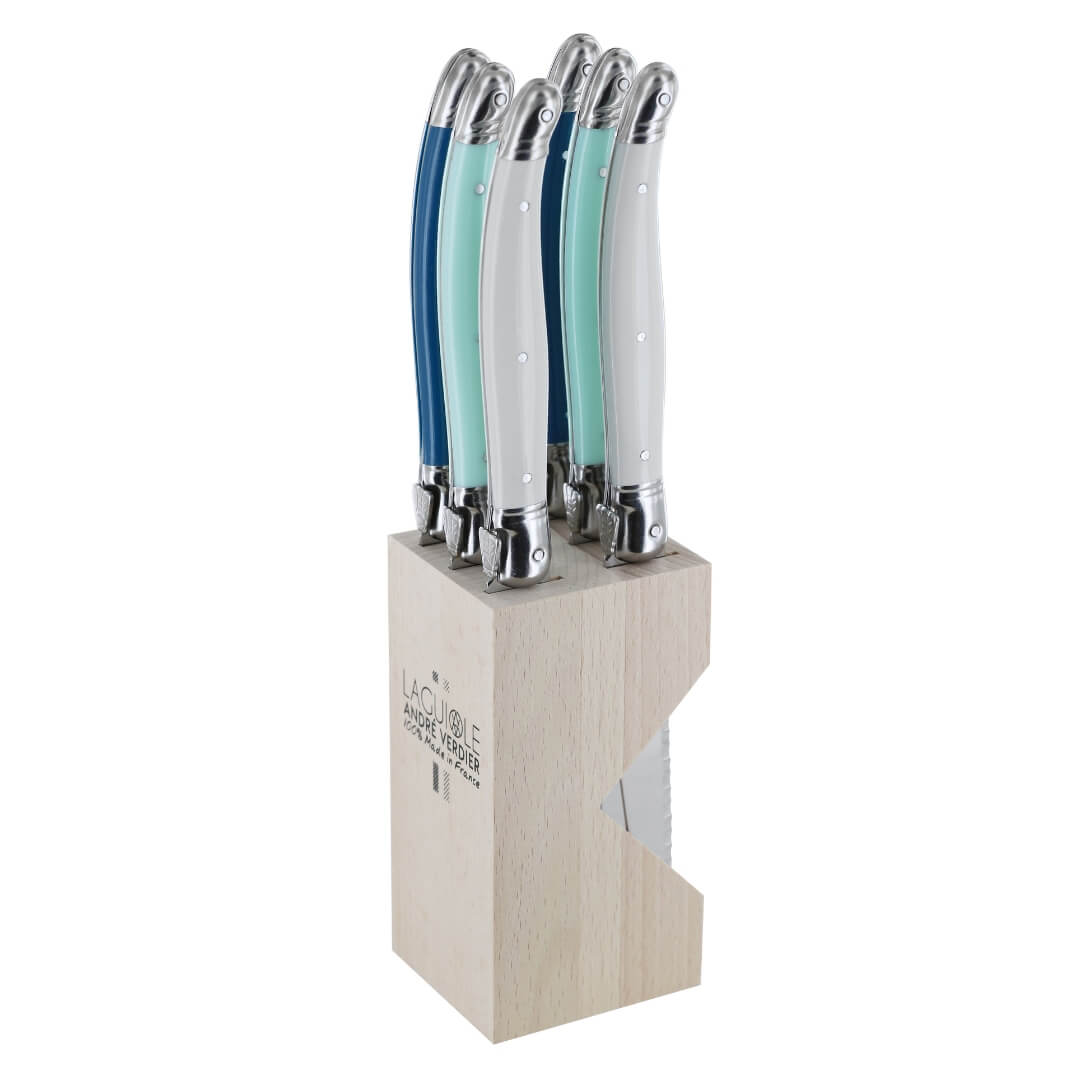 A 6-piece kitchen knife set with white, seafoam-mint green, and blue handles in a light wood block, photographed on a solid white background.