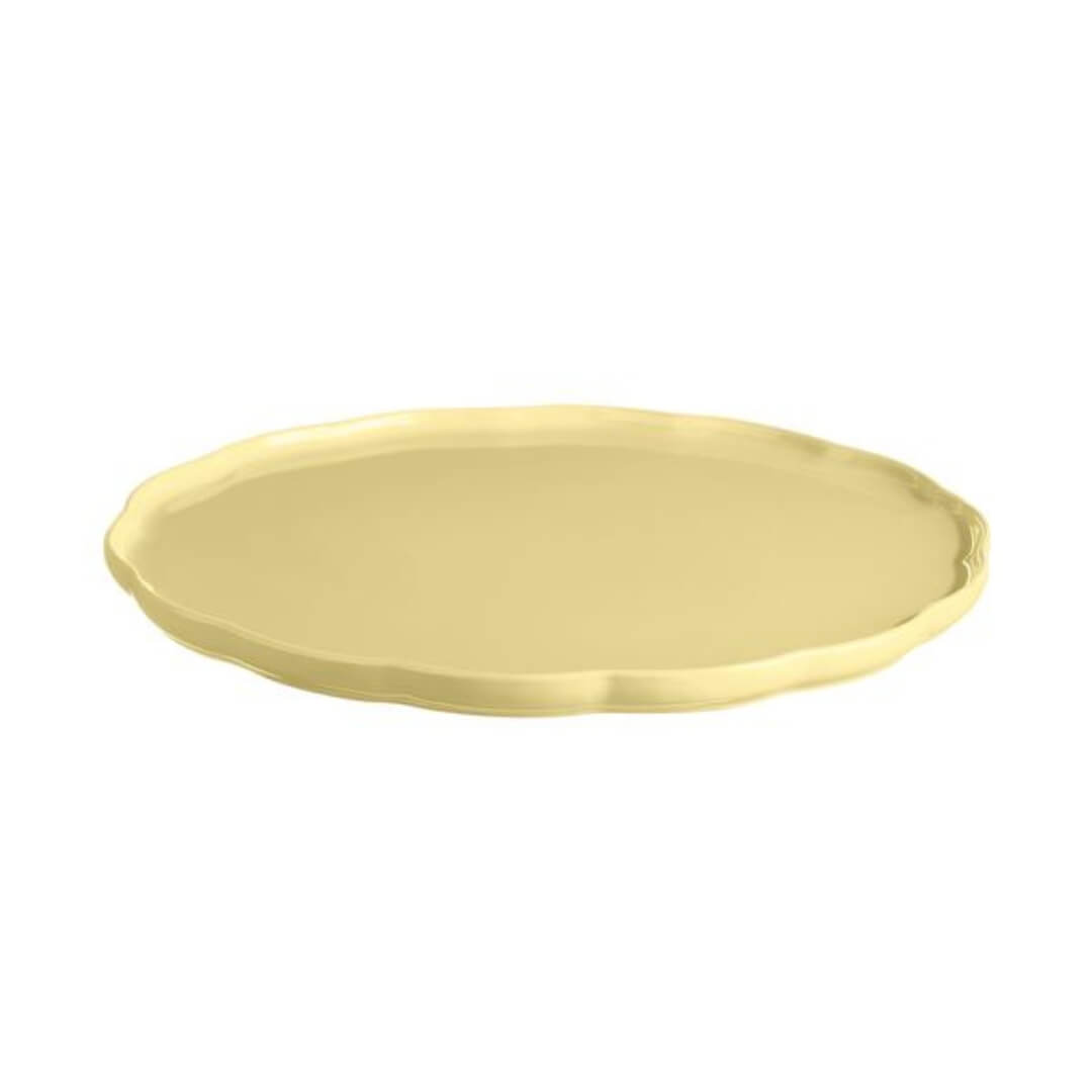 Yellow ceramic plate with scalloped detail edge on a white background