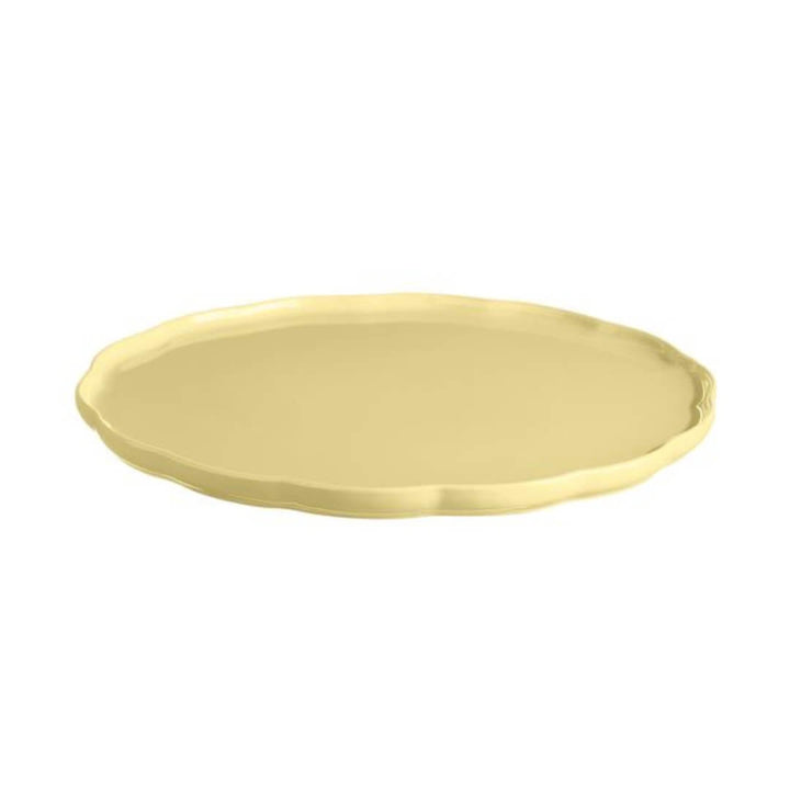Yellow ceramic plate with scalloped detail edge on a white background